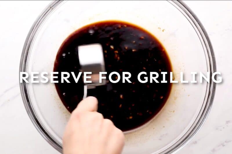 Reserving huli huli marinade for grilling.