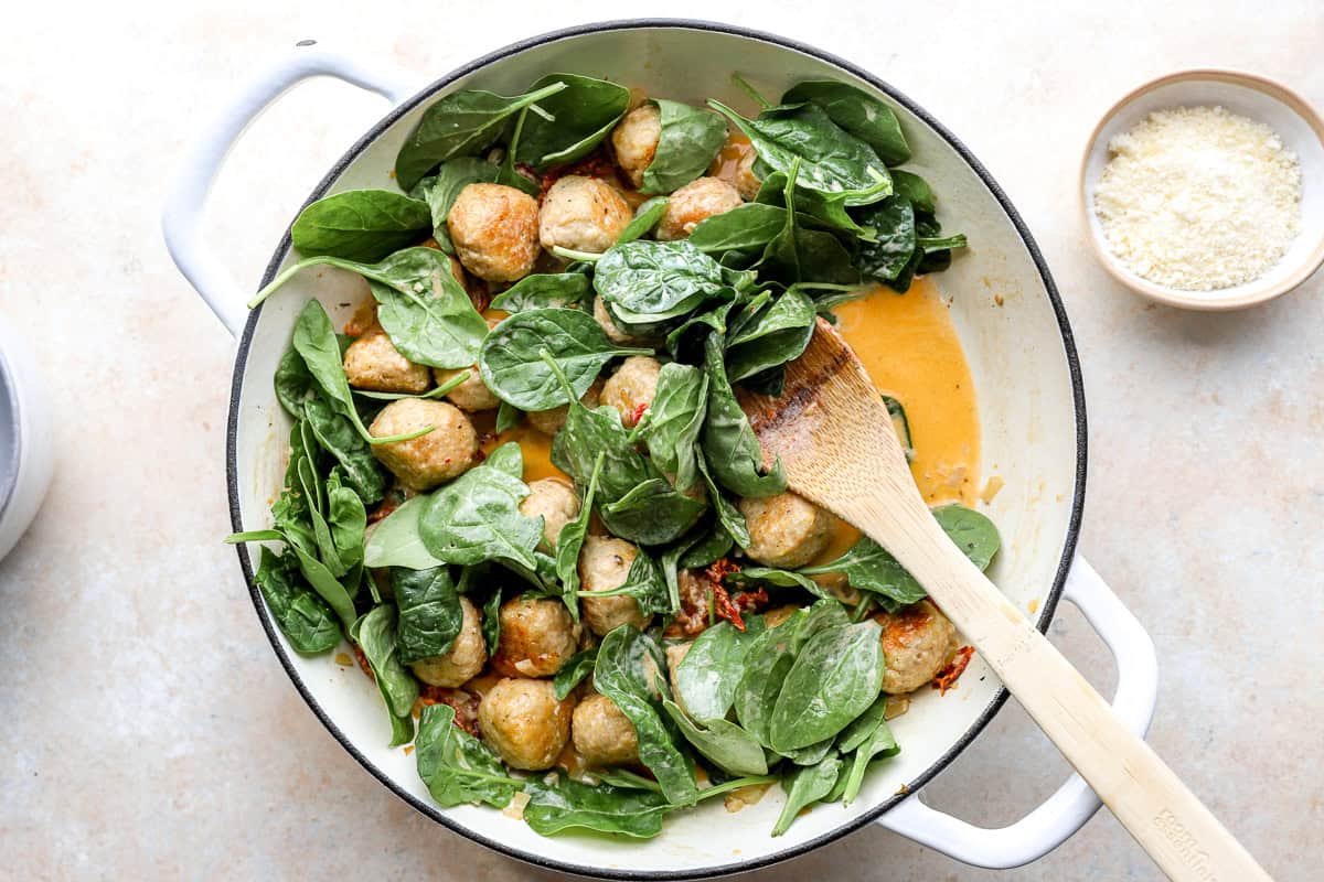 Wilting spinach in the skillet.