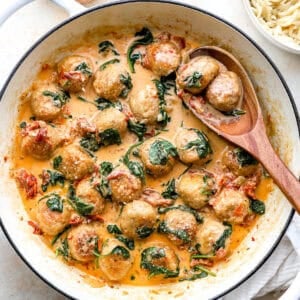 Marry me chicken meatballs in Tuscan sauce in a skillet.