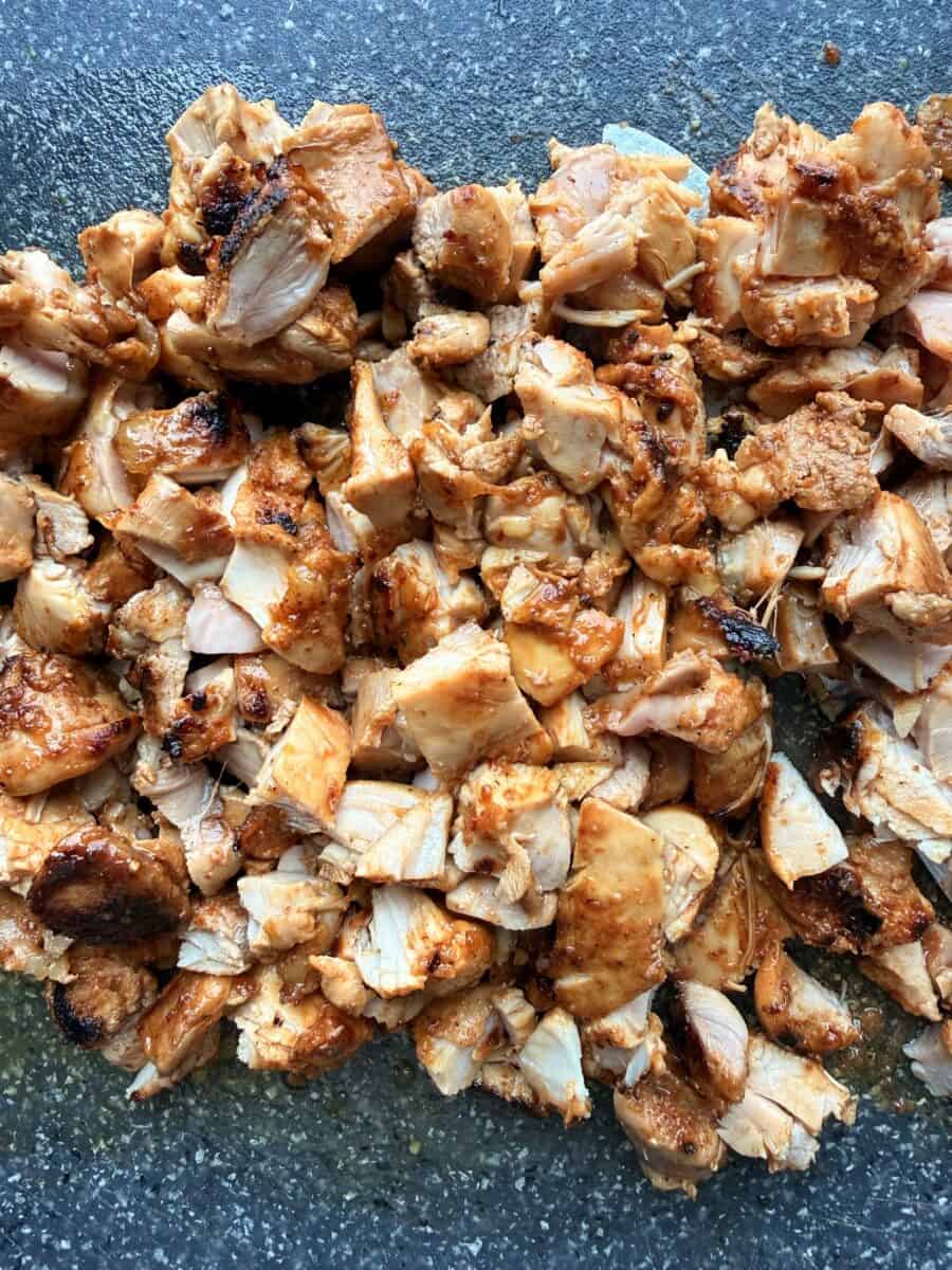 Chicken al pastor cut into bite-sized pieces.