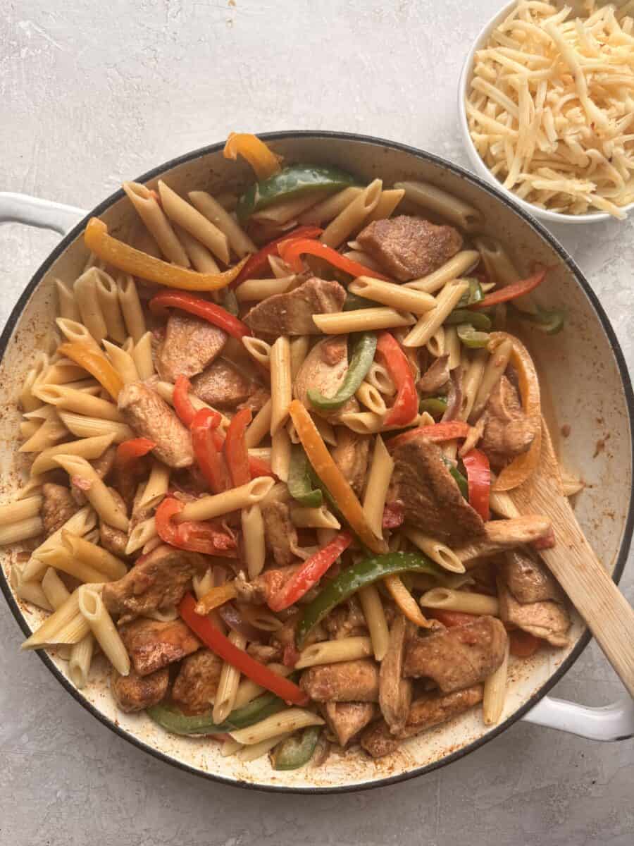 Cooking fajita chicken pasta in a pot.