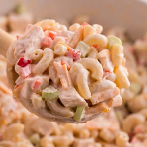 Close-up of a scoop of chicken macaroni salad.