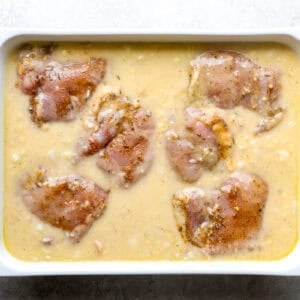 Chicken thighs in cream of soup mixture, before baking.