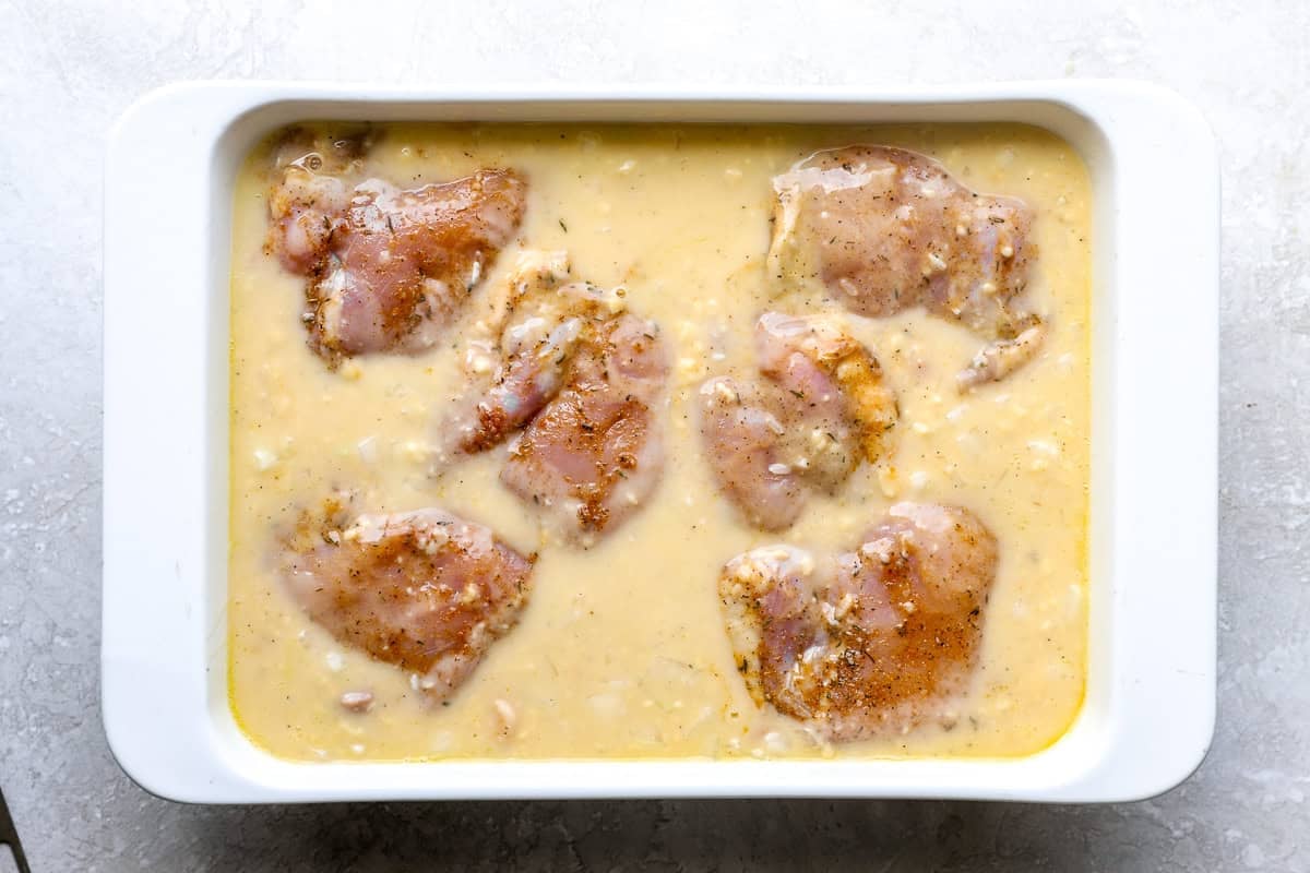 Chicken thighs in cream of soup mixture, before baking.