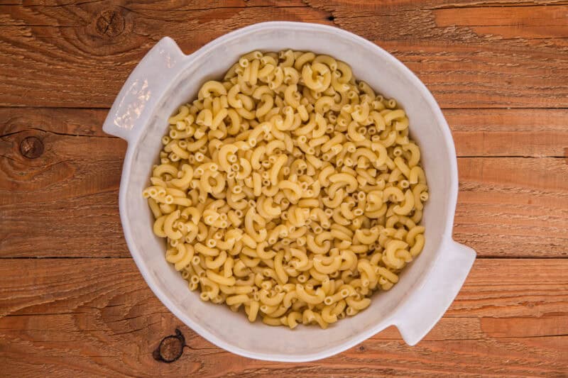 Cooked elbow macaroni in a large white bowl.