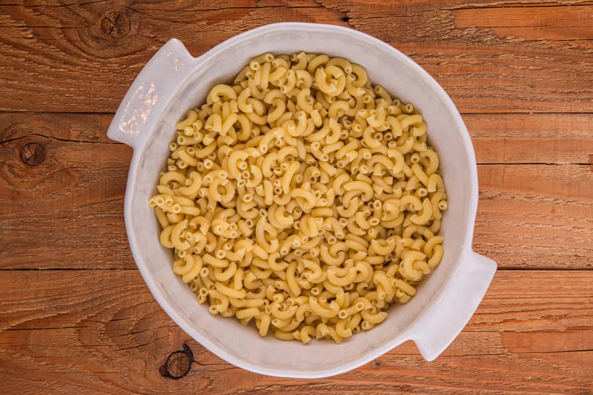 Cooked elbow macaroni in a large white bowl.