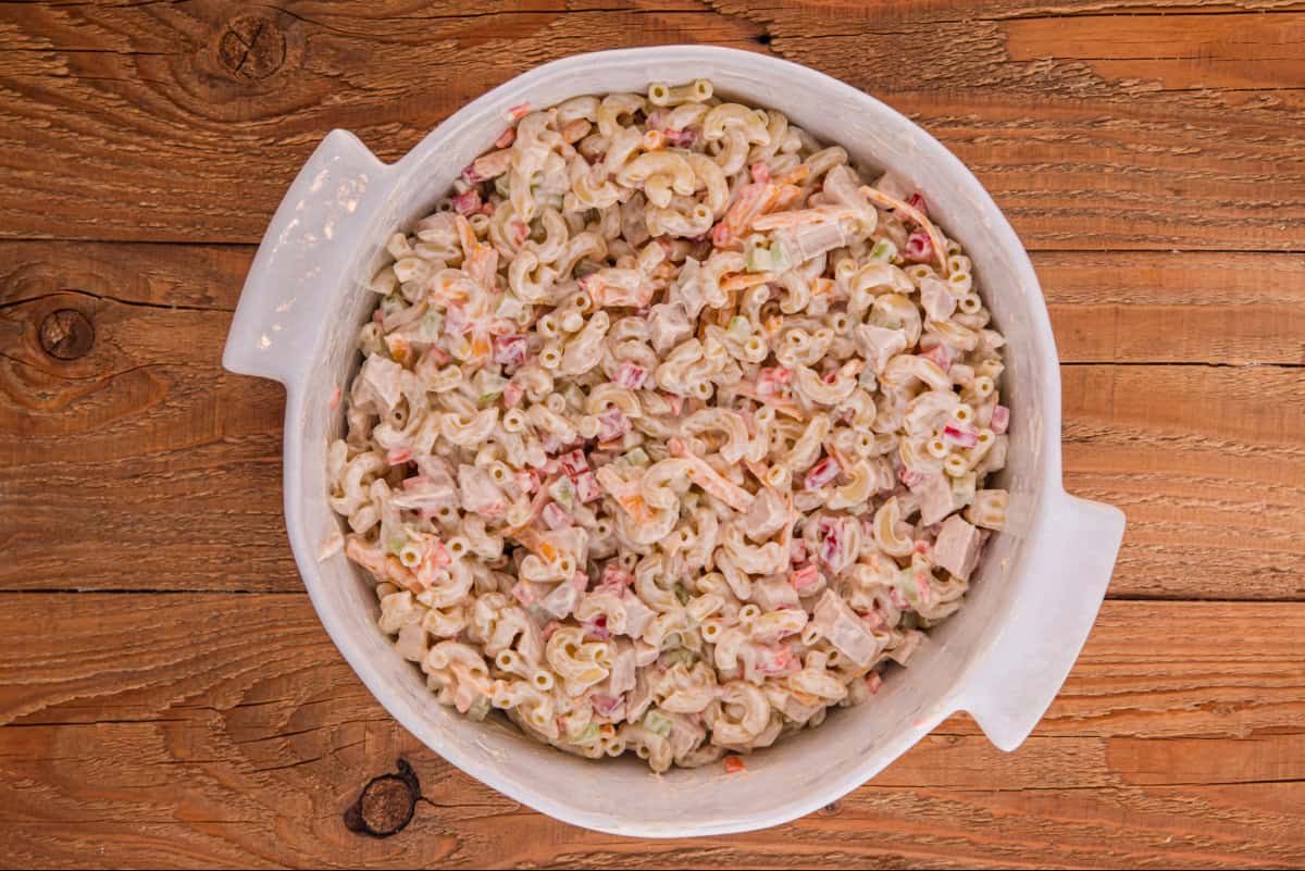 Cold chicken macaroni salad in a large white bowl.