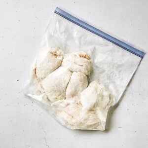 Chicken thighs in a zip lock bag with cornstarch.