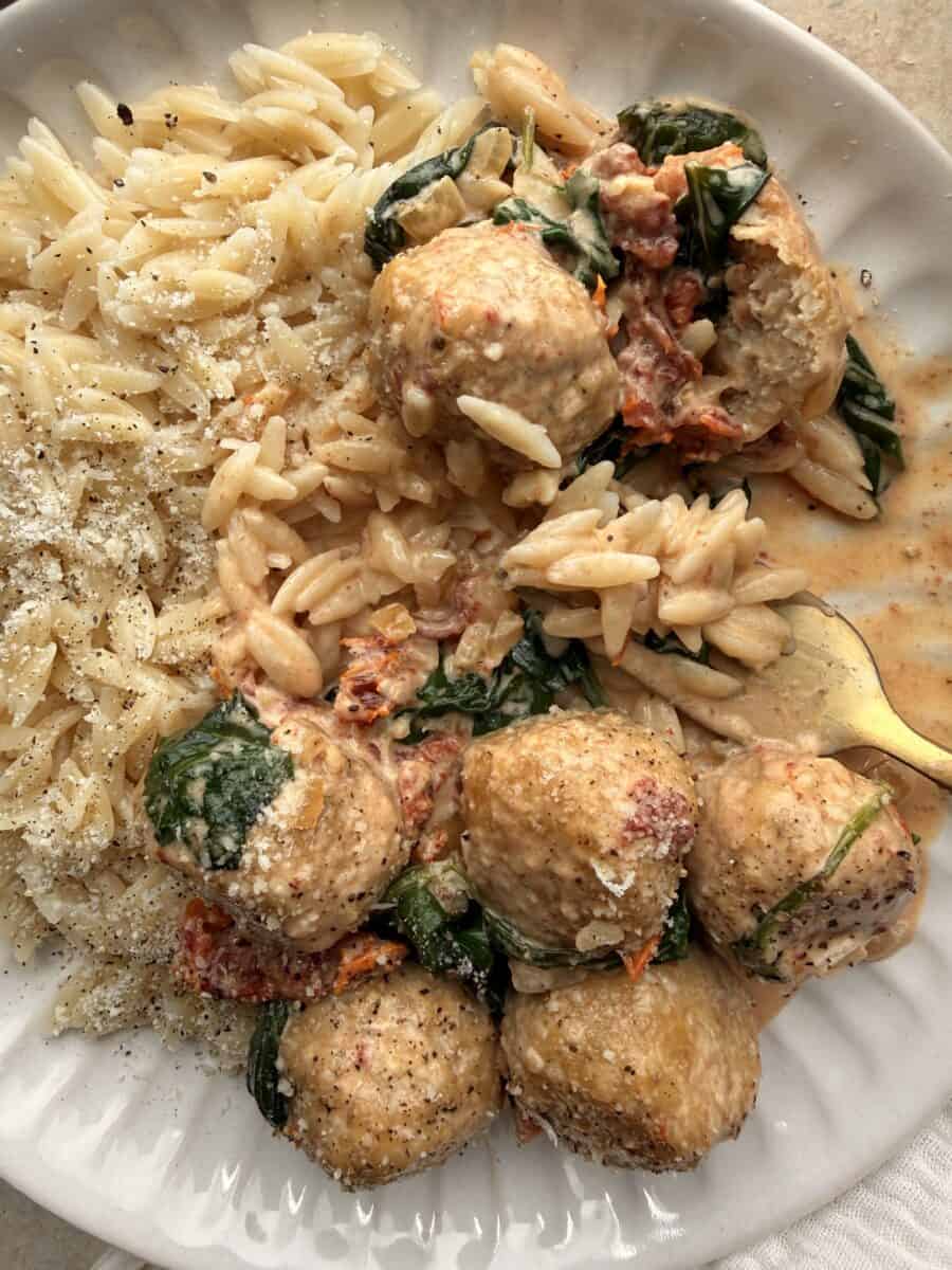 Marry Me chicken meatballs plated with orzo.