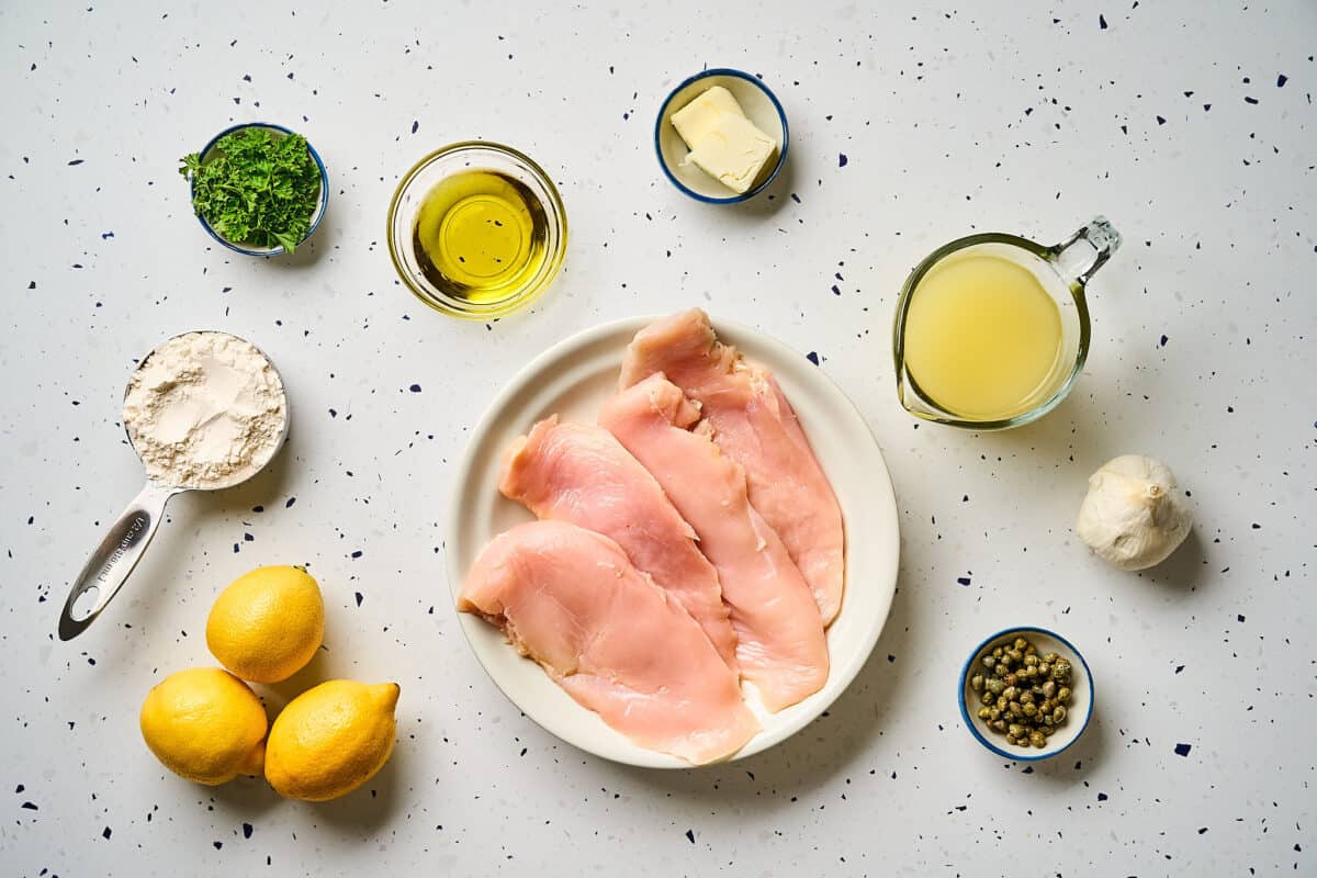Ingredients for chicken scallopini featuring chicken cutlets, all-purpose flour, kosher salt, black pepper, olive oil, butter, garlic, chicken broth, lemon juice, lemon zest, capers, and parsley.