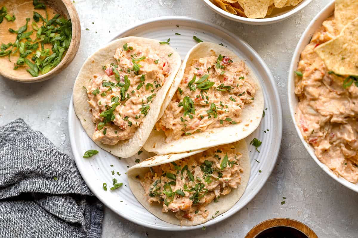 Crockpot queso chicken tacos on a plate.