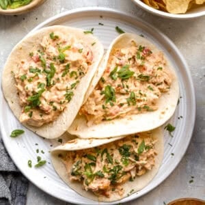 A plate of tacos filled with Crockpot queso chicken.
