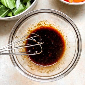 Whisking together soy sauce and brown sugar.