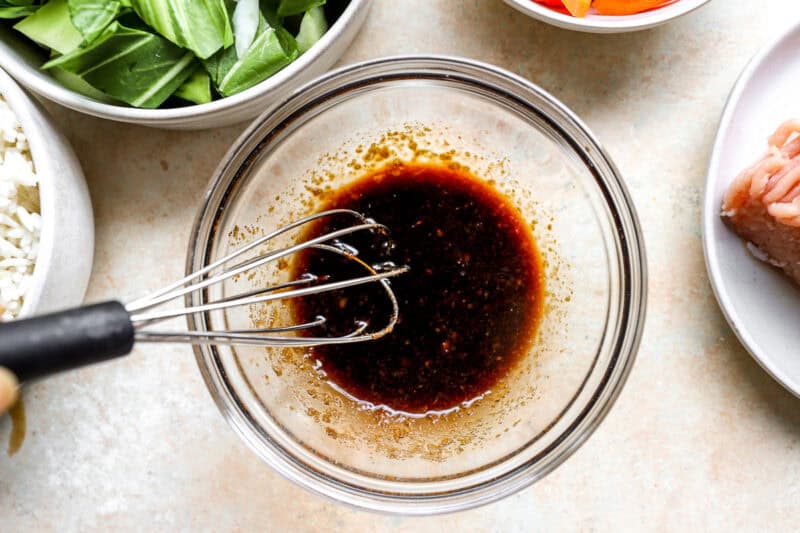 Whisking together soy sauce and brown sugar.