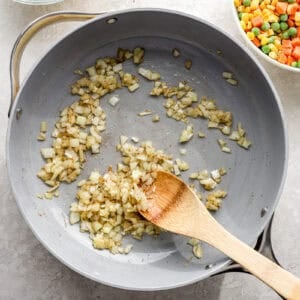 Onion and garlic sautéing in a pan.