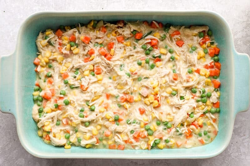 Chicken pot pie filling in a casserole dish.