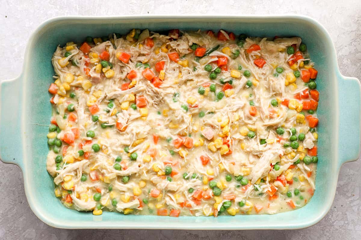 Chicken cobbler in a casserole dish ready to bake.