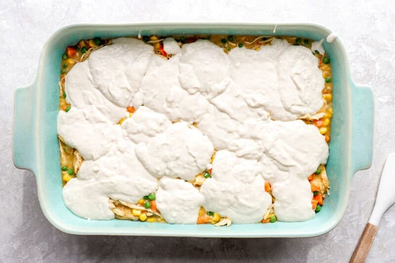 Dollops of biscuit batter on top of the chicken and veggie filling.