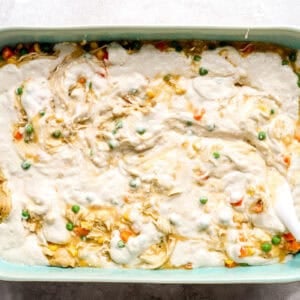 Swirled biscuit batter over chicken cobbler filling.