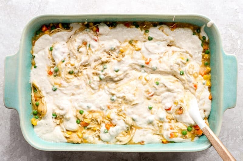 Swirled biscuit batter over chicken cobbler filling.