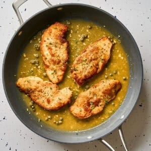 Chicken piccata in a pan.