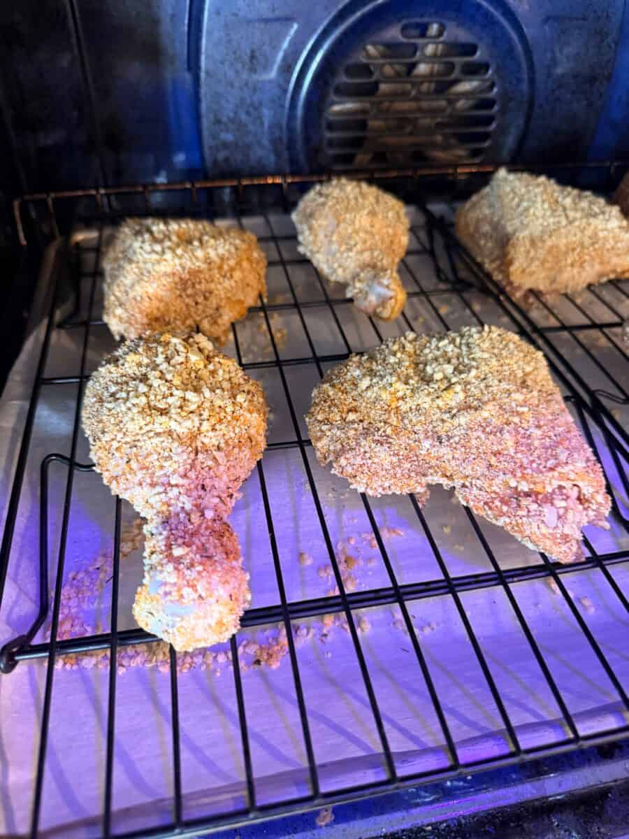 Shake and bake breaded chicken baking in the oven.
