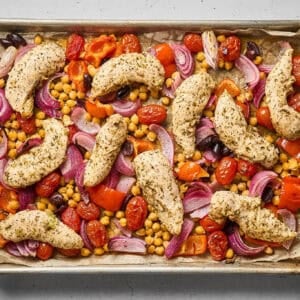 Greek chicken and vegetables in a sheet pan, after roasting.