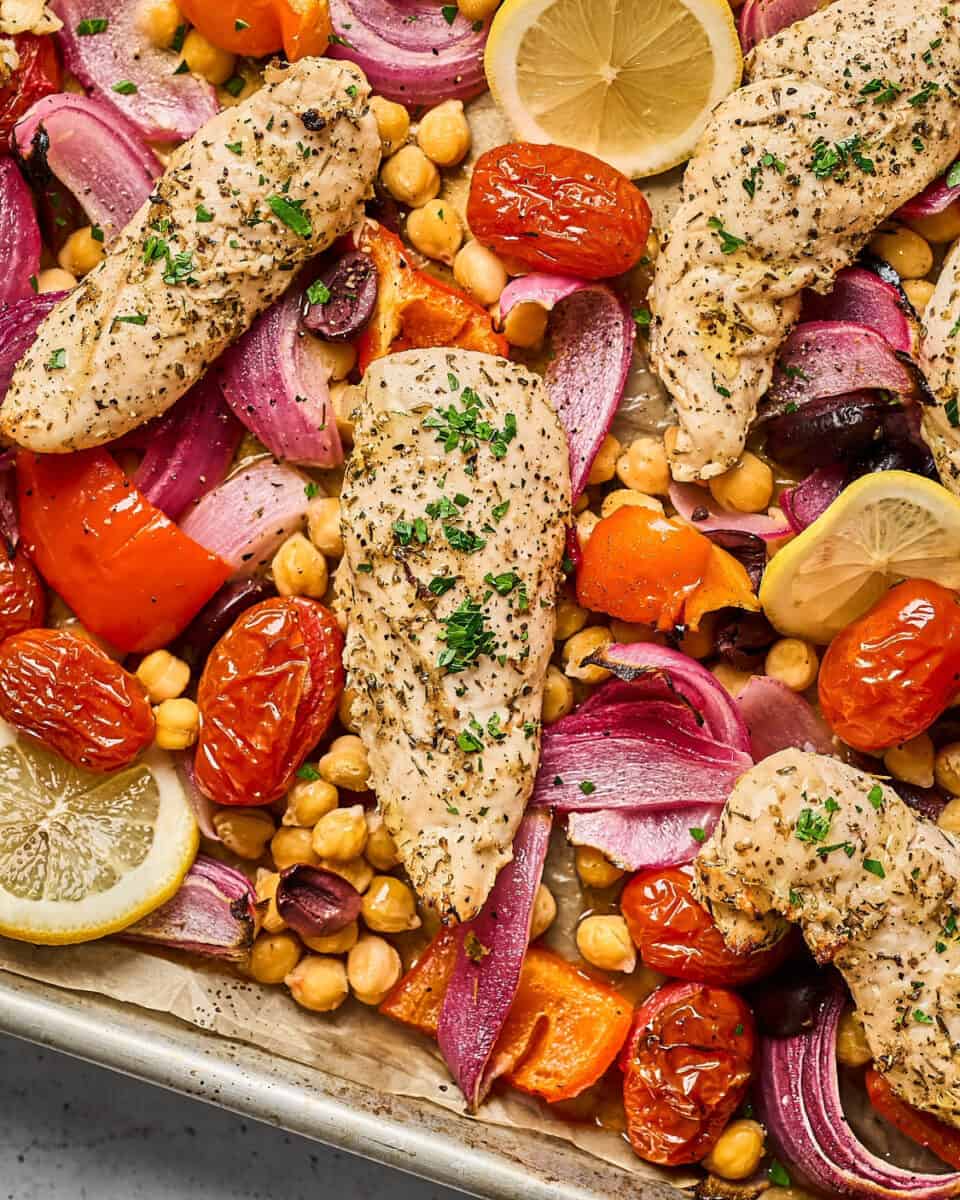 Greek-marinated chicken tenders, chickpeas, and Mediterranean vegetables roasted in a sheet pan.