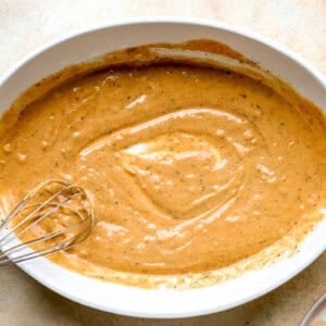 Whisking together a homemade tahini sauce.