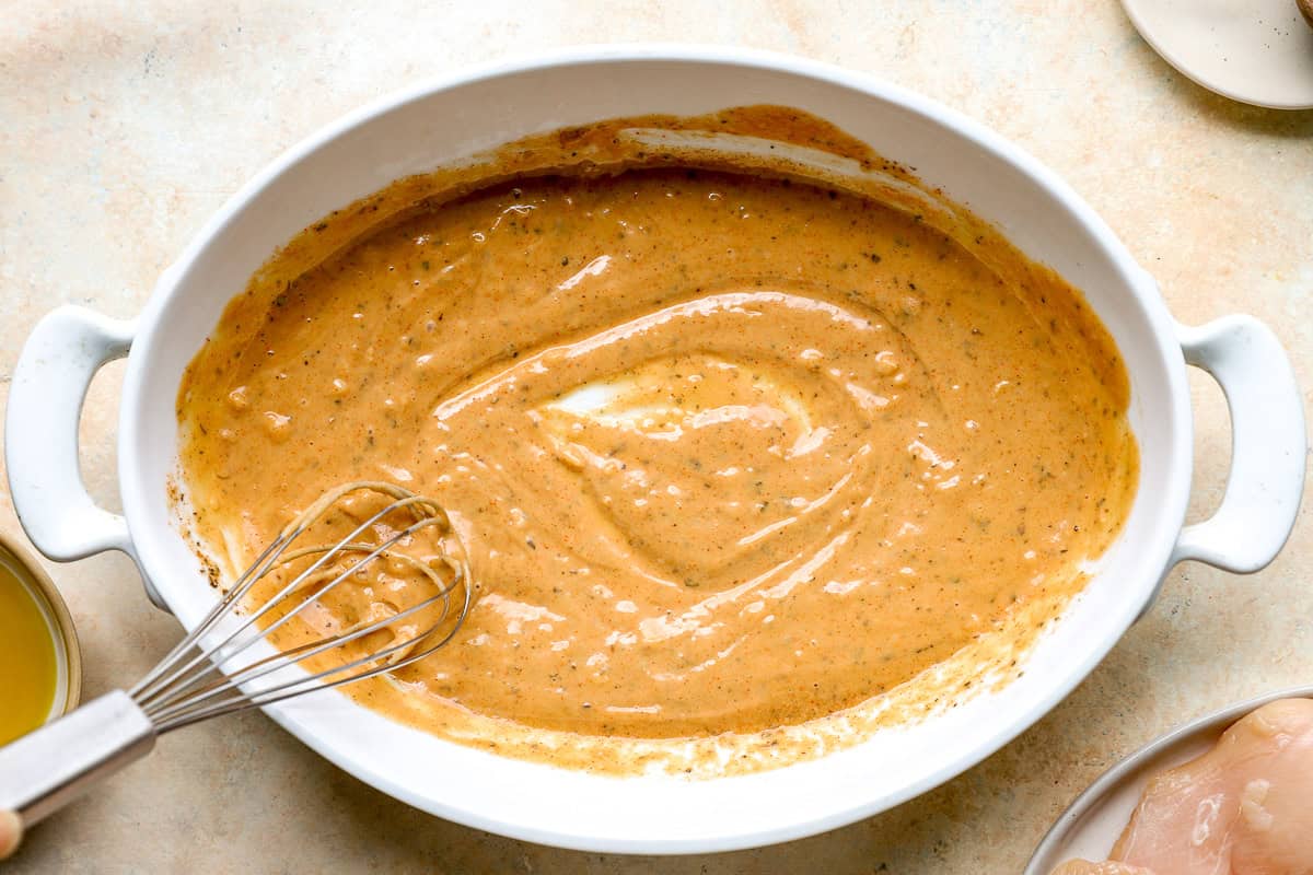 Whisking together a homemade tahini sauce.