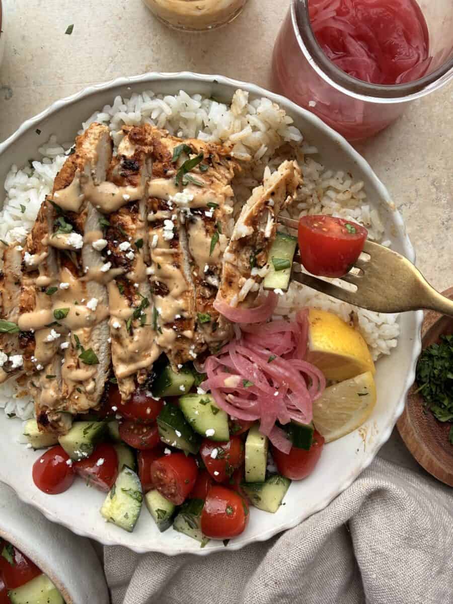 Eating a tahini chicken bowl.