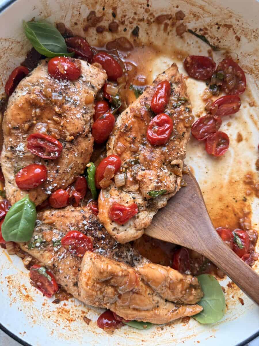 Scooping up a serving of tomato basil chicken breast.
