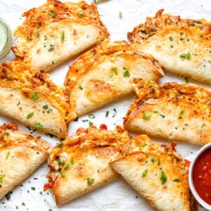 Cheesy baked chicken tacos served with salsa and cilantro lime sauce.
