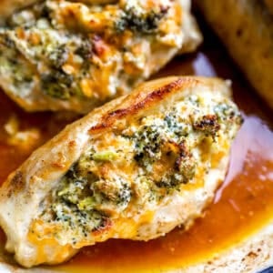 Broccoli and cheese stuffed chicken breasts in a pan.
