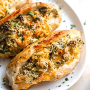 Broccoli cheese stuffed chicken breasts on a serving plate.