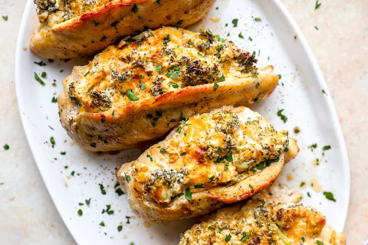 A plate of broccoli and cheese stuffed chicken breasts.