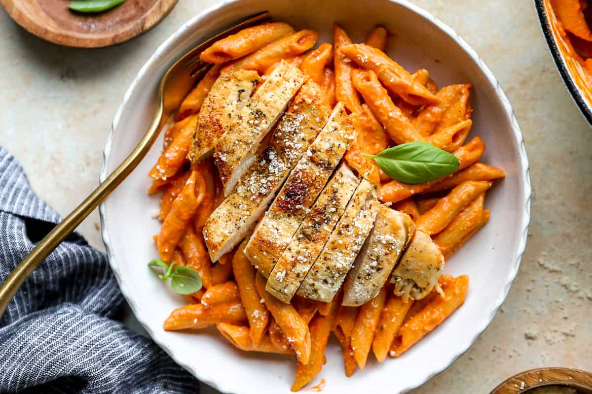 A serving of chicken penne pasta with creamy vodka sauce.