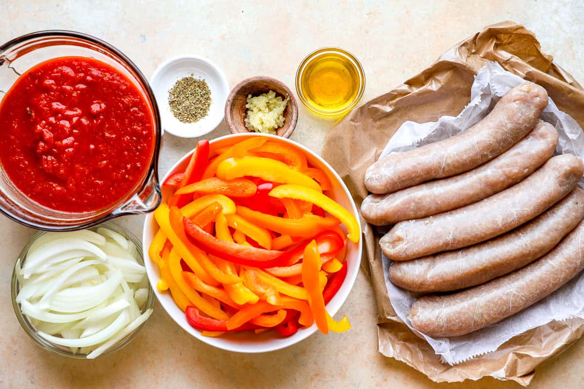 Ingredients for crockpot chicken sausage and peppers: Italian chicken sausage, onions, bell peppers, and marinara sauce.
