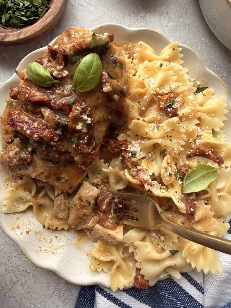 A serving of slow cooker marry me chicken with pasta.