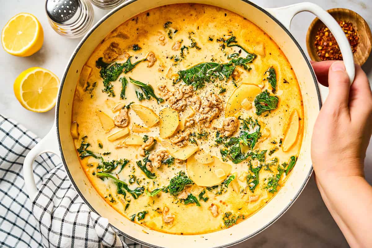A pot of homemade Zuppa Toscana filled with ground chicken, potatoes, and kale.
