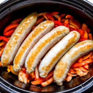 Chicken sausage, peppers, and onions in a slow cooker.