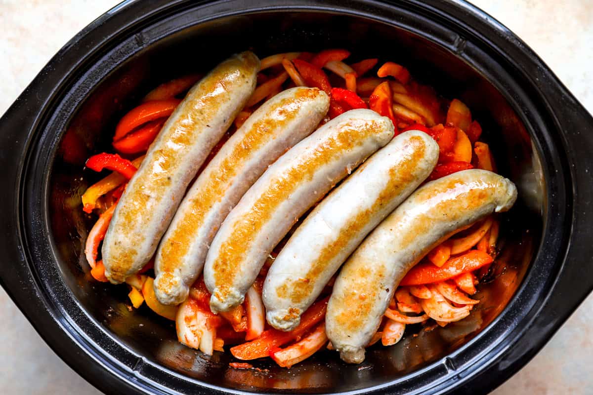 Chicken sausage, peppers, and onions in a slow cooker.