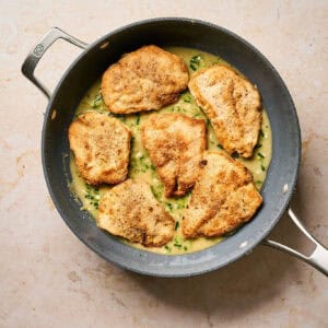Cooking chicken cutlets with almondine sauce.