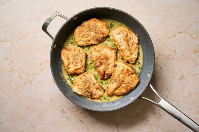 Cooking chicken cutlets with almondine sauce.