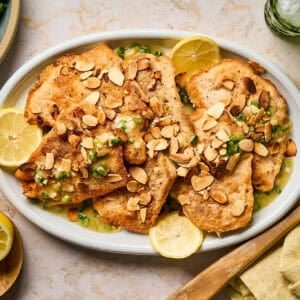 Cooked chicken almondine served on a platter.