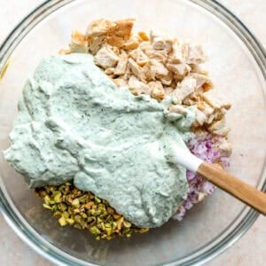 Combining leftover chicken and pistachios with homemade green goddess salad dressing.