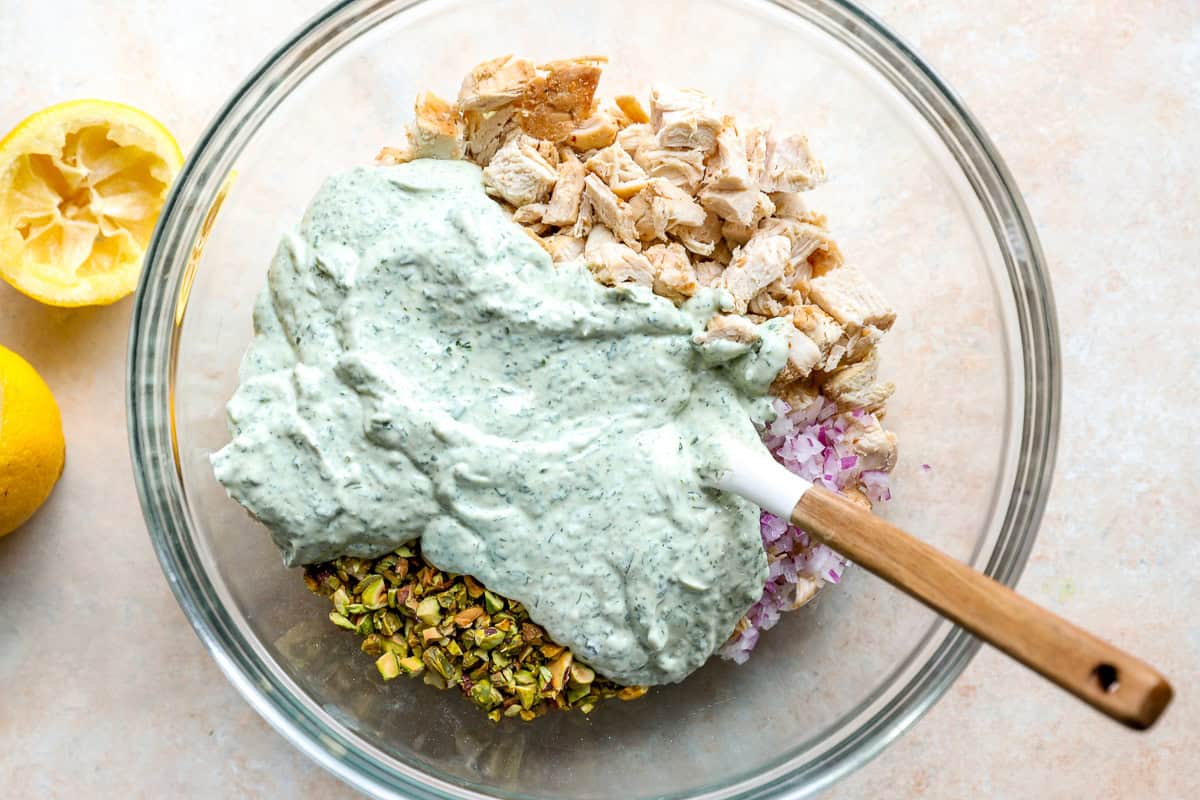Combining leftover chicken and pistachios with homemade green goddess salad dressing.