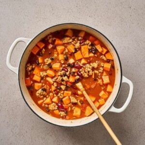 Sweet potato chicken chili ingredients combined in a pot.