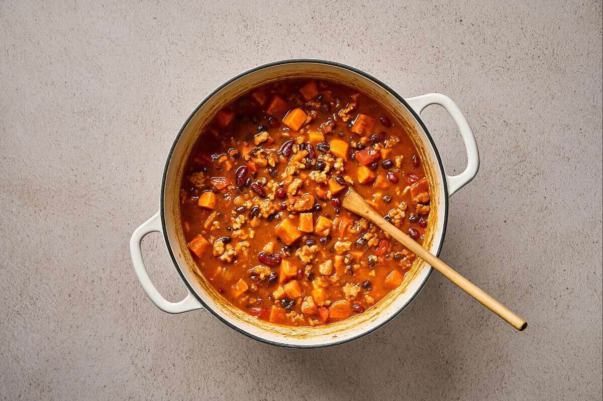 Sweet potato and ground chicken chili cooking in a pot.