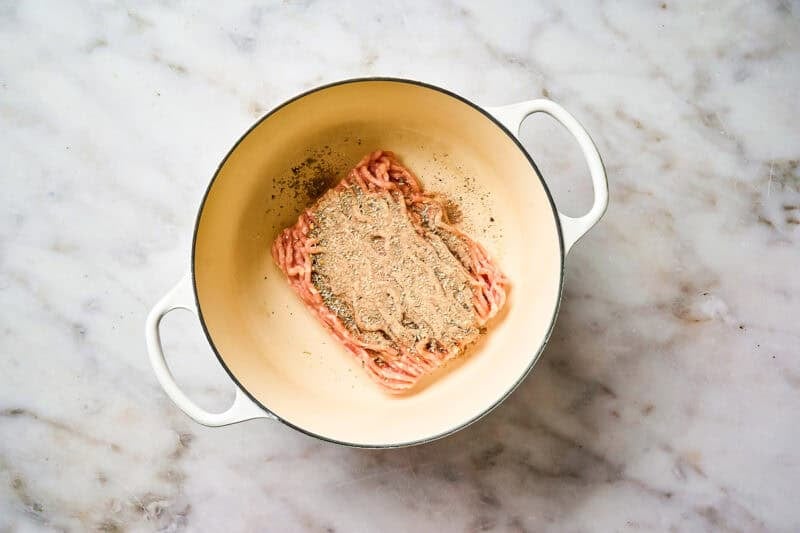 Seasoned ground chicken in a pot.